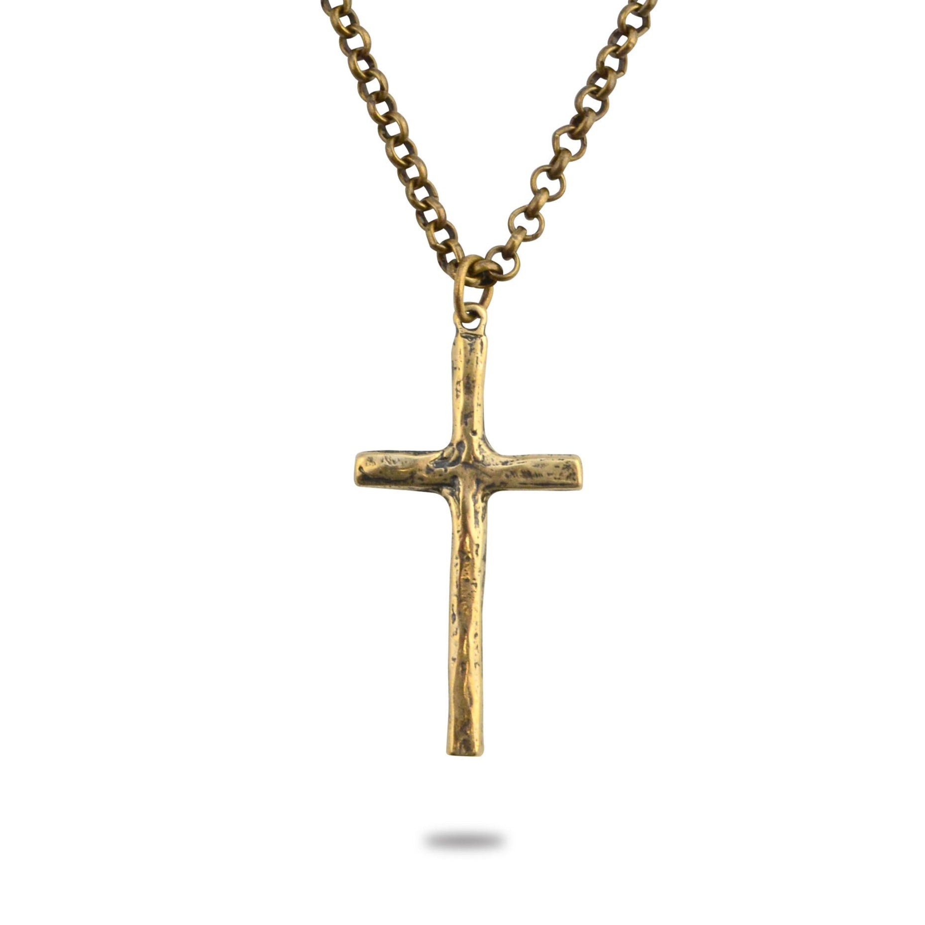 A gold-colored bronze necklace featuring a hammered cross pendant on a brass chain.