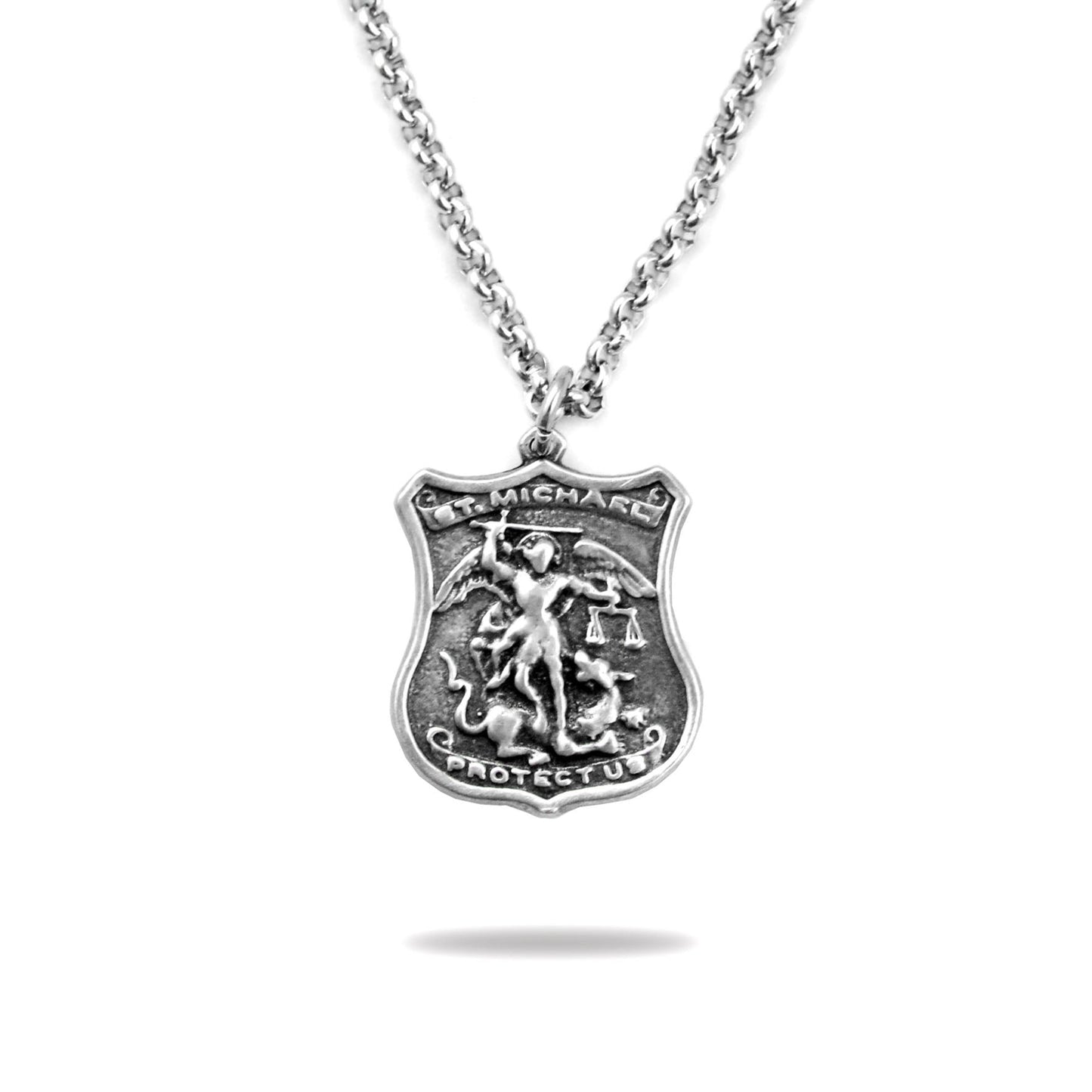 A silver pendant necklace featuring an engraved shield with St. Michael's emblem and the prayer 'Protect Us'.