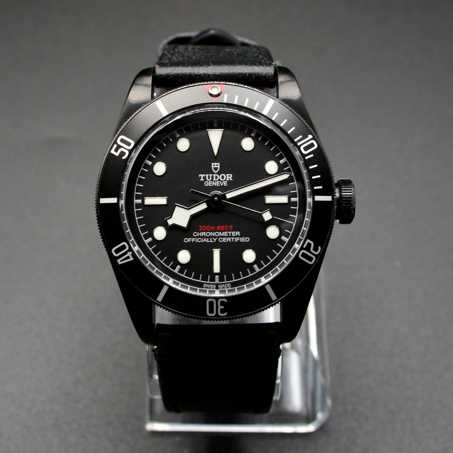 Black Tudor watch on a gray background